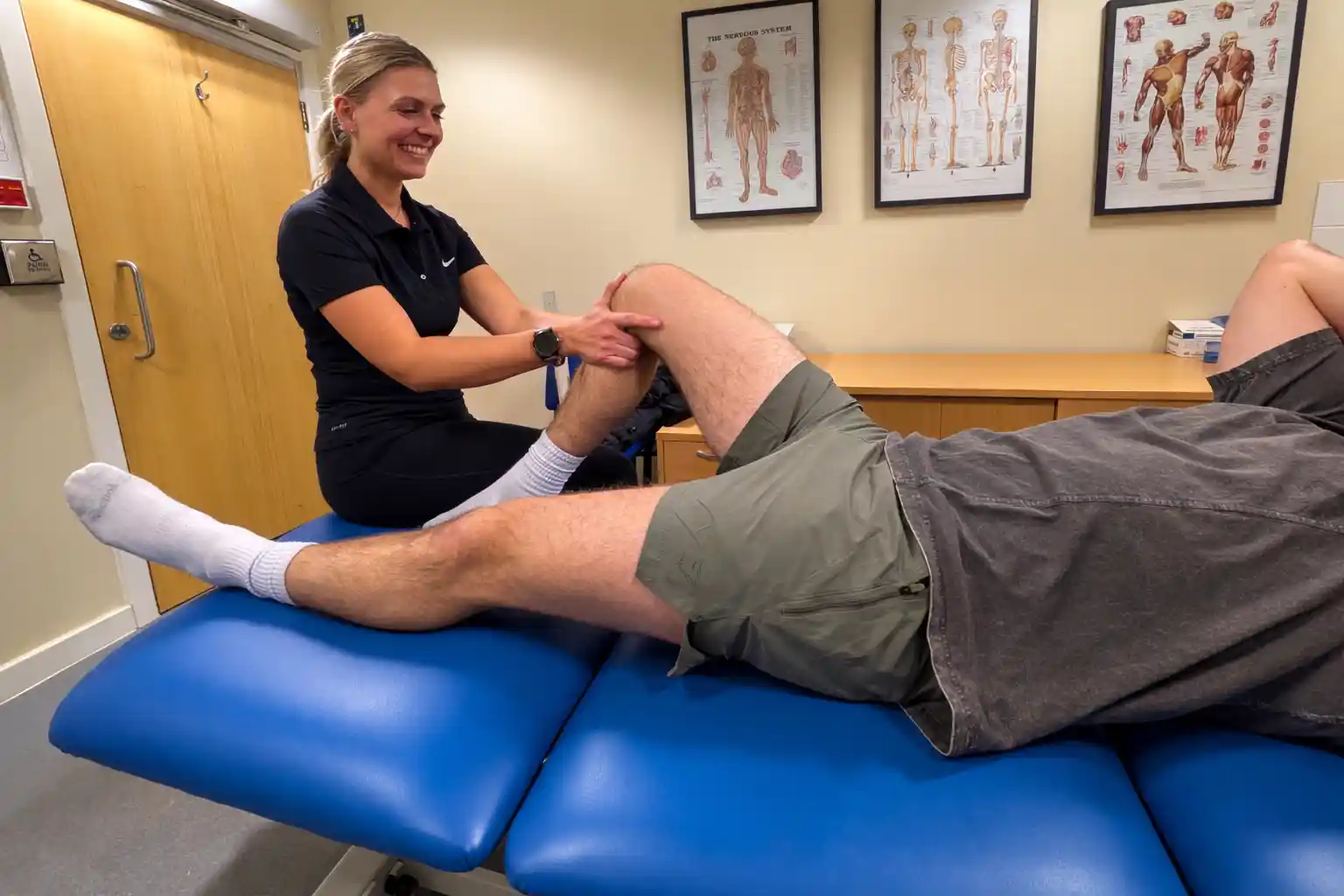 Physiotherapist performing a knee assessment and manual therapy on a patient during treatment at Phoenix Physio clinic